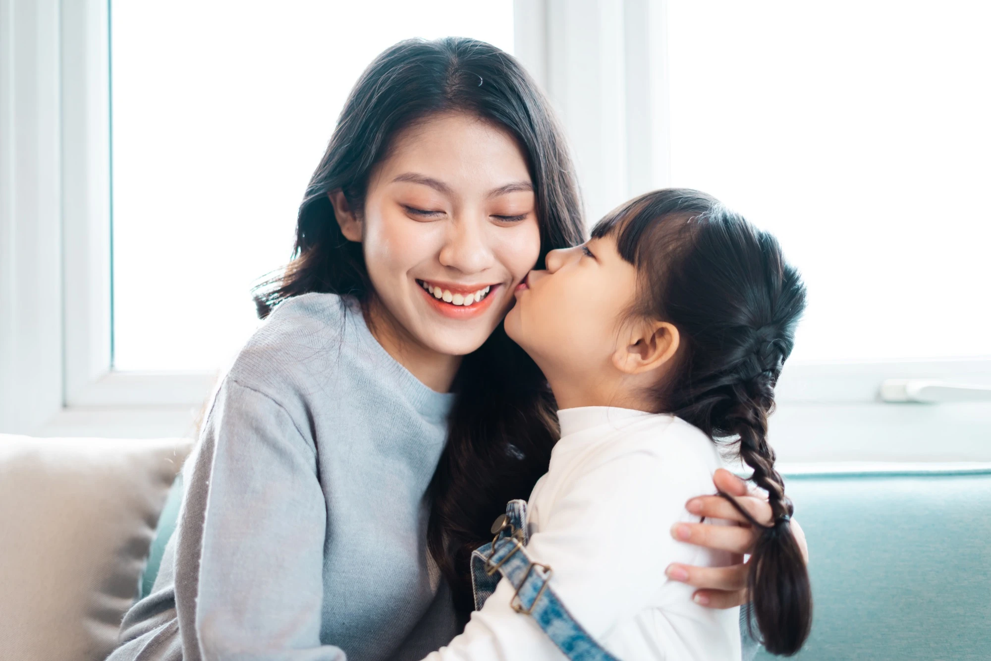 Parent and child sharing a confident smile after pediatric dental care