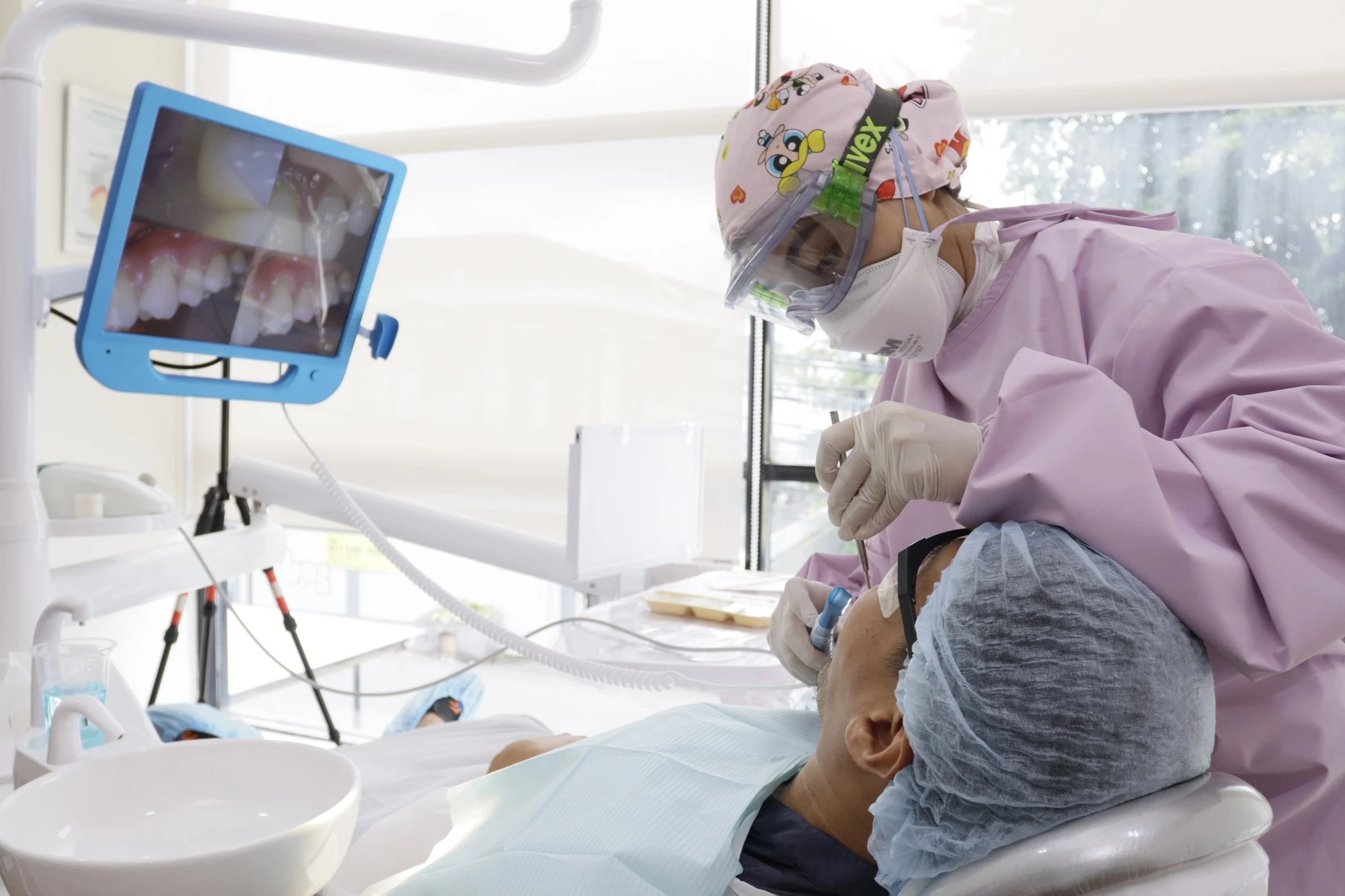 Dentist using an intraoral camera during examination